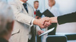 © yurolaitsalbert - confident businessman shaking hands with his business partner.