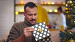 © TommyStockProject - Portrait of handsome man opening Christmas present and feeling disappointed