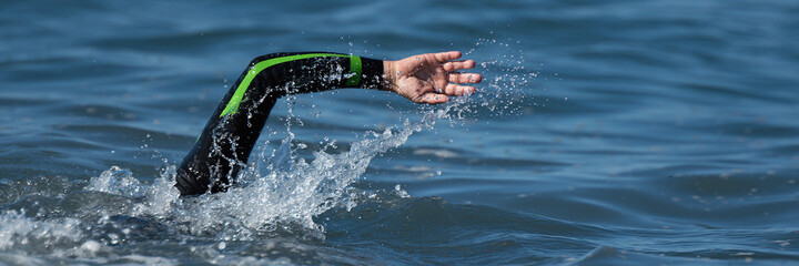 Wall Mural - Swimmer floating crawl into the blue sea