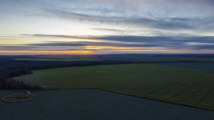 Wall Mural - Beautiful rural landscape bird's-eye view at sunrise, hyperlapse. Aerial view of agricultural landscape with fields in autumn season. 
