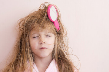 Wall Mural - little girl brushes her tangled hair after a shower