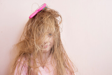 Wall Mural - little girl brushes her tangled hair after a shower
