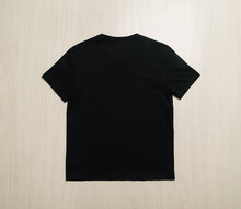 Black T-shirts Mockup Template On Wooden Floor.