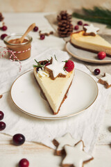 Wall Mural - Delicious Christmas cheesecake with cranberries and cookies stars on a white table