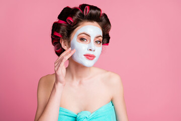 Sticker - Close-up portrait of attractive housewife wearing applying natural organic clay mask isolated over pink pastel color background