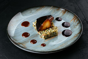 Wall Mural - grilled fish with rice and vegetables on a black background