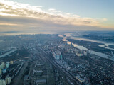 Fototapeta Miasto - Aerial high flight over Kiev, haze over the city. Autumn morning, the Dnieper River is visible on the horizon.