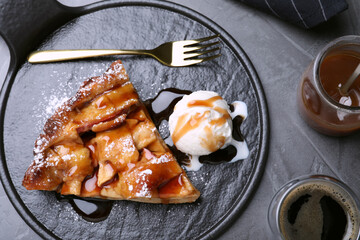 Slice of traditional apple pie with ice cream served on grey table, flat lay