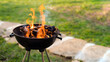 Burning wood in barbeque grill, preparing hot coals for grilling meat in the back yard. Shallow depth of field