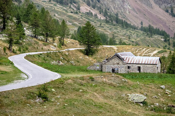 Abandoned and ruined stone house on the way up the winding road to the Col de la Lombarde, border between Italy and France, commune of Vinadio, Piedmont region, province of Cuneo, Italy