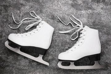 Wall Mural - pair of white ice skates on grey background, top view