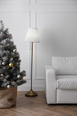 Wall Mural - Christmas tree near sofa against in room. Interior design