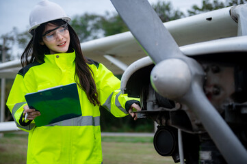 Technician fixing the engine of the airplane,Female aerospace engineering checking aircraft engines,Asian mechanic maintenance inspects plane engine