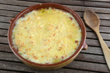 prepared meal bowl of potatoes and onion gratin as vegan food