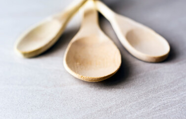 Wall Mural - Group of wooden kitchen spoons arranged on a gray marble table