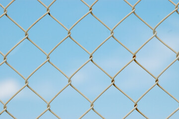 Full frame macro photo of a metal net fence, texture and background concept
