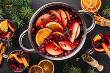Top-down View Of Cooking Pot Of Hot Wine With Aromatic Spices On A Black Textured Background. Christmas Mulled Wine. New Year's Warming Drink.