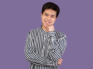 Portrait of attractive asian guy posing at studio