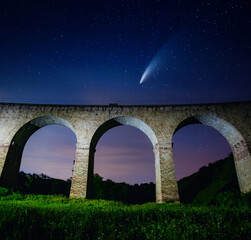 Wall Mural - fantastic starry sky over the old viaduct. long exposure shot, astrophotography.