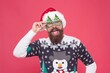 © be free - santa guy in hat and party glasses like his favorite winter sweater having fun on new year holiday, winter holiday