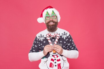 Wall Mural - cheerful party goer in santa hat and knitted sweater feel joy and prepare for christmas celebration, christmas presents