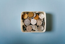 Coins In A Box, Indonesian Currency Coins Rupiah On A Blue Background.