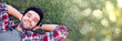 © JuYochi - The caucasian man was happily lying on the grass with a bokeh copy space.