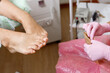 © Николай Крапивин - The pedicure master takes out the sterilized tools from the craft package. Professional pedicure in a medical salon. Visiting an orthopedic podiatrist.