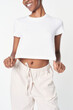 © Rawpixel.com - Women&#39;s white crop top with sweatpants minimal outfit
