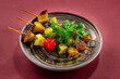 grilled vegetables, kebab on burgundy background