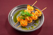 shrimp kebab grilles on burgundy background