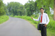 © PRASANNAPIX - Young indian agronomist using smart phone on road side and asking lift