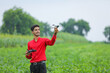 © PRASANNAPIX - Indian agronomist holding drone and remote in hand at agriculture field