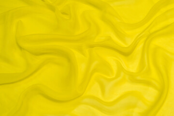 Wall Mural - Abstract yellow silk chiffon fabric texture. A mockup of silk tissue as background at  the artistic layout.