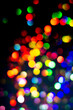 © Julia Klintsova - Christmas tree garland light. Colorful bokeh blurry decor on black background. Holiday wallpaper night glowing. City light dark overlay defocused holographic ray. Abstract blurred clipart