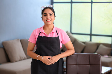 Portrait of a beautician smiling in her uniform	