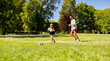 © Syda Productions - family, fatherhood and people concept - happy father and little son with ball playing soccer at summer park