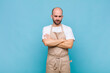 © kues1 - bald man feeling displeased and disappointed, looking serious, annoyed and angry with crossed arms