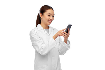 Wall Mural - medicine, technology and healthcare concept - happy smiling asian female doctor or scientist with stethoscope using smartphone over white background