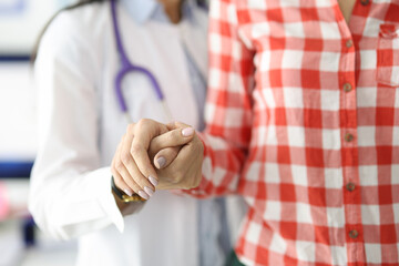 Wall Mural - Doctor supporting patient by hand and helping to go to clinic