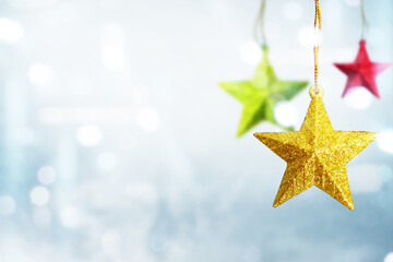 Colorful Christmas star hanging with blurred light background