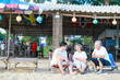 © sutthichai - Happy Asian family enjoy talking together on the sunbed on the beach side restaurant.