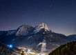 Dolomites by nightSky with stars on a winter night in val di fassa. Dolomites, forest and night lights of Pozza di Fassa