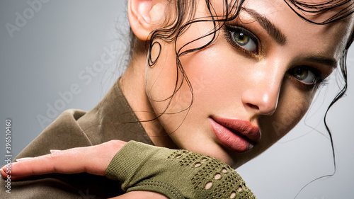 Fotografering Closeup portrait of a beautiful young fashion woman with glamour makeup posing at studio