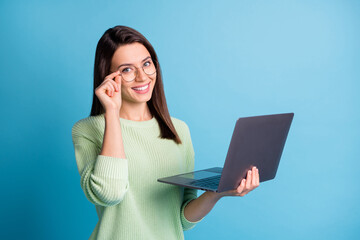 Wall Mural - photo of smart girl work on laptop touch specs wear green pullover isolated over blue color backgrou