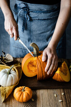 Person Cutting Halloween Pumpkin Closeup