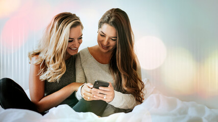 Wall Mural - Women watching an online clip from a phone