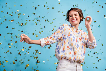 Photo of young woman happy positive smile fun joy enjoy music dance fly serpentine star isolated over blue color background