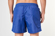 © Rawpixel.com - Man in blue board shorts rear view