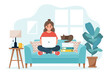 Home office concept, woman working from home sitting on a sofa, student or freelancer.